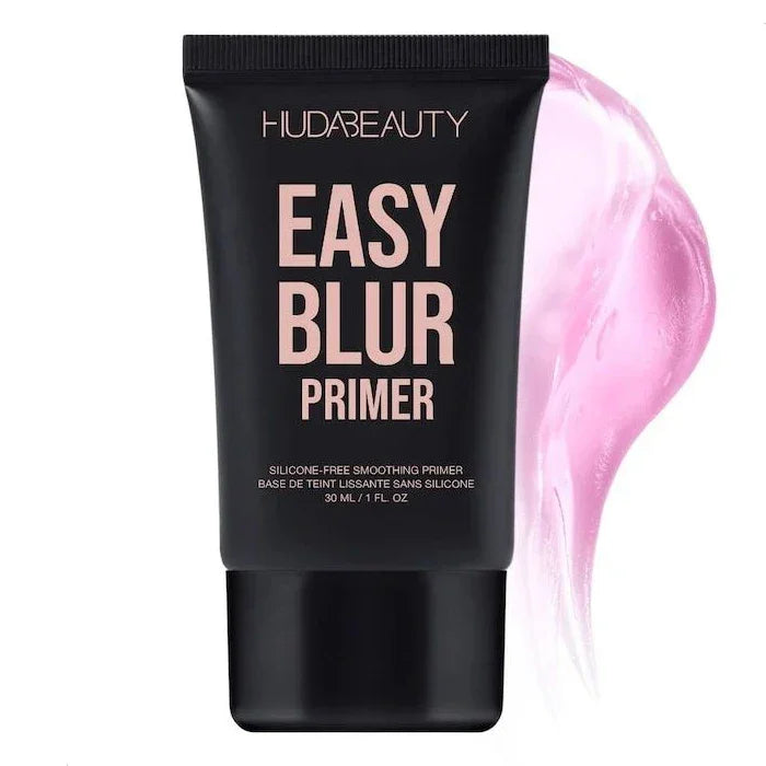 Primer facial Huda Beauty Easy Blur en envase negro de 30 ml con textura rosa de fondo.